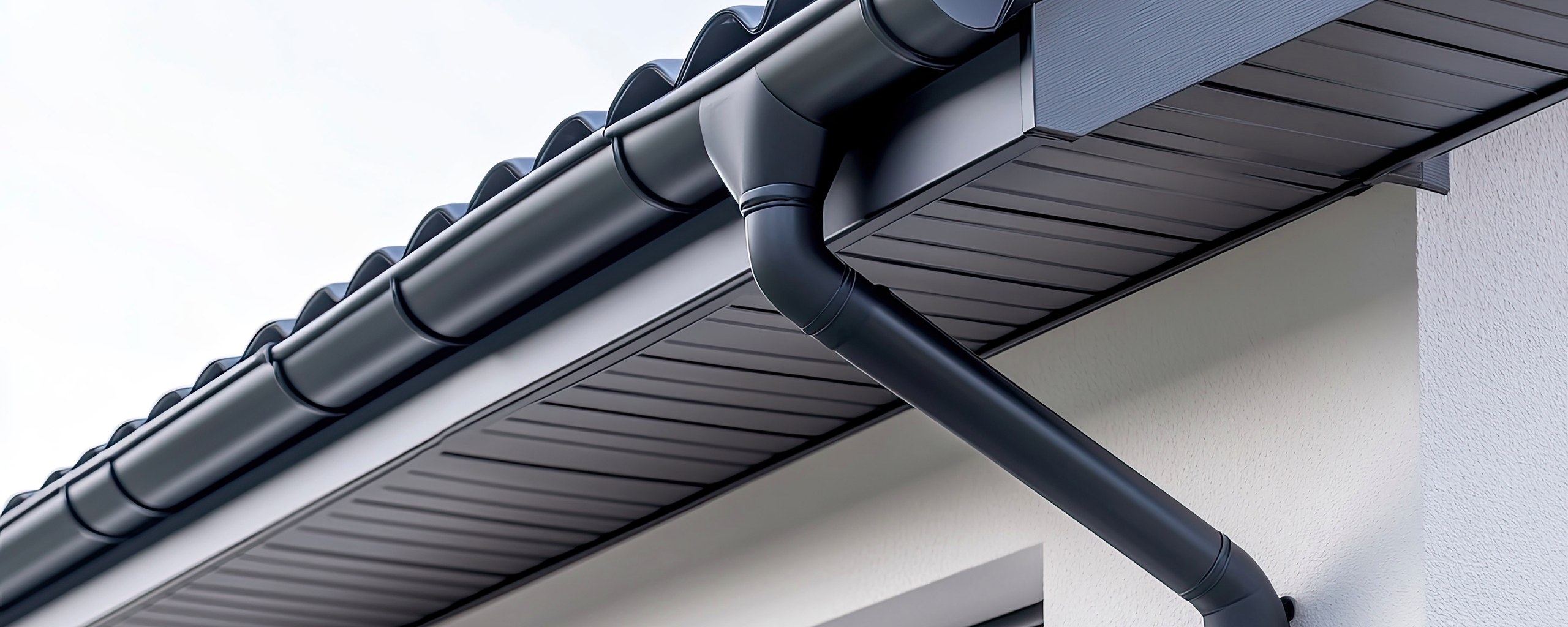 Seamless gutter and downspout installation on a modern home